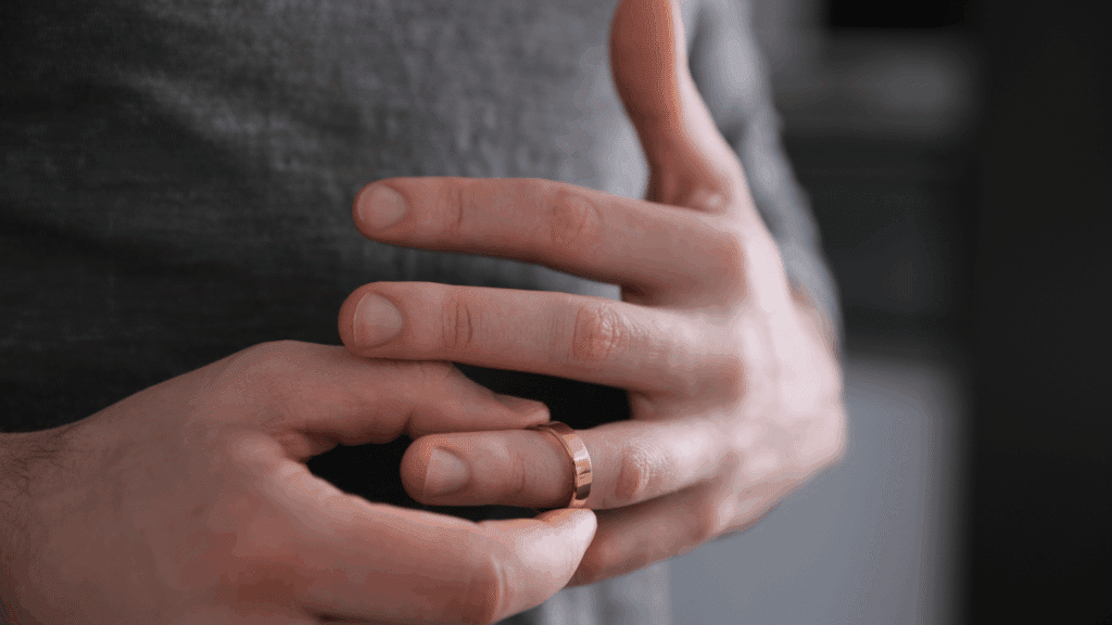 Woman removing wedding ring from finger